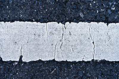 靠近道路上古老的白色交通线。