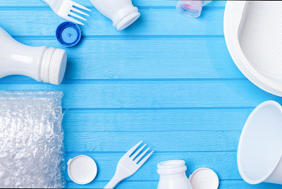 White plastic waste for recycling on blue backgrou