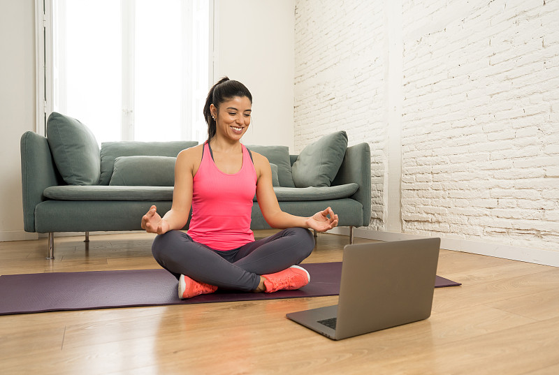 Young beautiful latin woman working out at home co