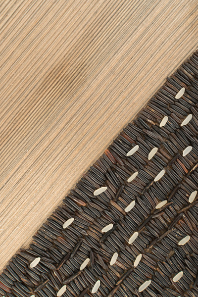 Raw Black Wild Rice on Wood Background