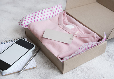 孩子们的衣服放在打开的纸板箱里