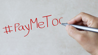 #PayMeToo文本在纸上背景。