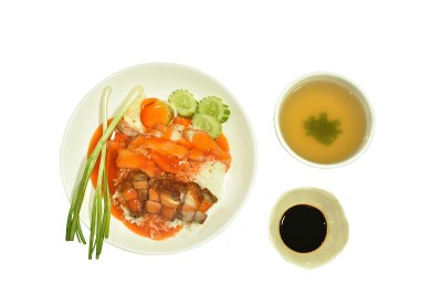 香脆烤猪肉片，浇上白米饭调味的甜红肉汁