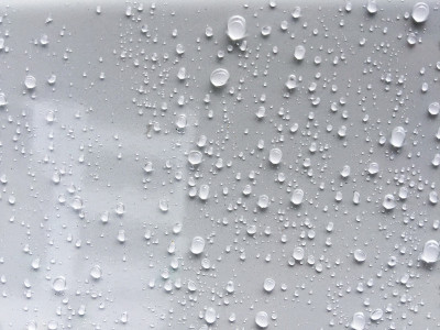 水滴在灰白的汽车的彩色表面上