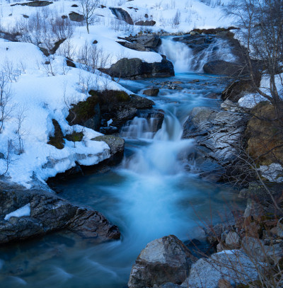 Røldal瀑布在冬末，山坡被雪覆盖