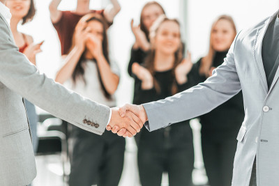 close up. business handshake on the blurred backgr