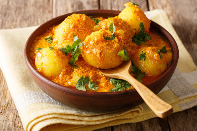 克什米尔dum aloo:盘子上的辣味土豆和酱汁。水平
