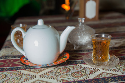 阿塞拜疆传统armudu茶梨形玻璃杯。阿塞拜疆红茶，白糖块。白色水壶和糖碗。白色陶瓷茶壶。阿木都杯阿