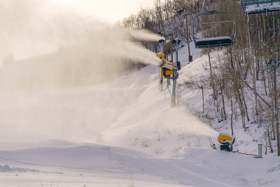 雪山斜坡上的雪炮和滑雪缆车