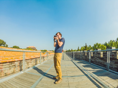 Enjoying vacation in China. Young man in Forbidden