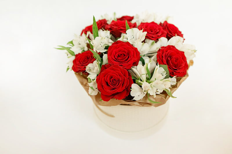 Bouquet with red roses and white flowers in round 