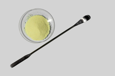Optiblanc粉末放在化学手表玻璃旁边的搅拌棒。化学美容护理实验台(俯视图)。