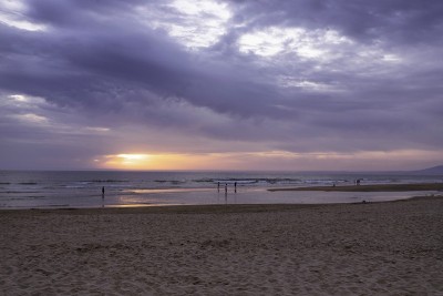 A few people relaxing on the beautiful beach in Ca