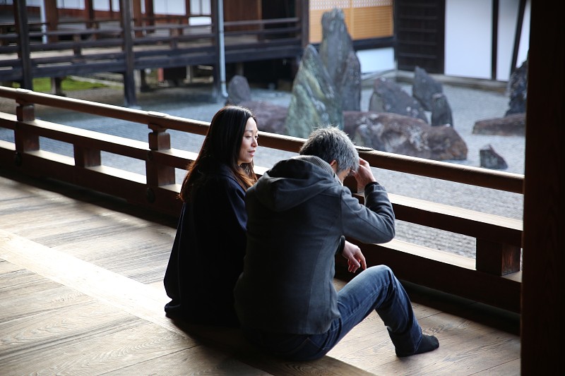 一对游客坐在秋寺