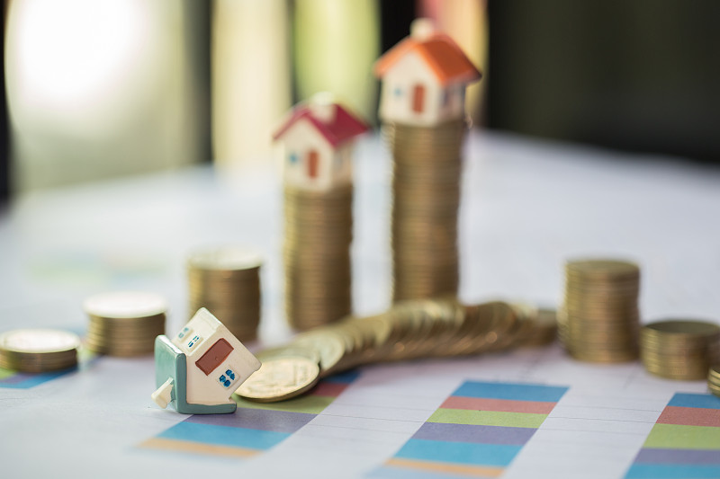 Mini house on stack of coins,Money and house, Mort