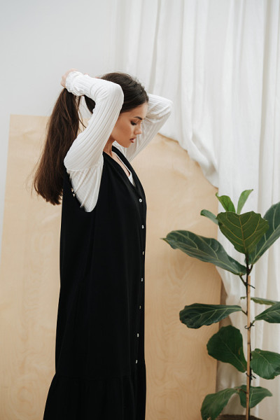 Side view of a young beautiful woman putting her l