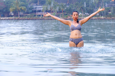 Woman in bikini exercise in morning at beach Koh C