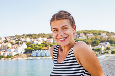 Woman at the adriatic seashore on a summer morning