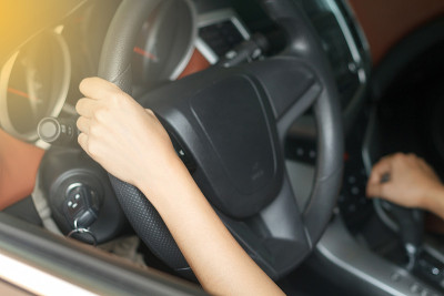 亚洲妇女在路上开车。