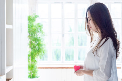 有吸引力的亚洲女人持有心的象征