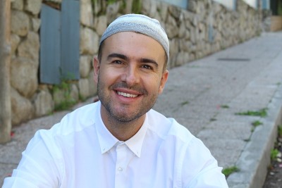 Cheerful Islamic man smiling at camera