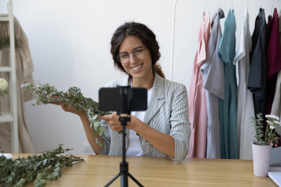 Smiling female florist shoot video tutorial on cel