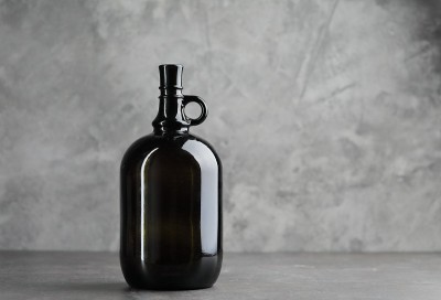 Wine bottle on a concrete background. Free space f