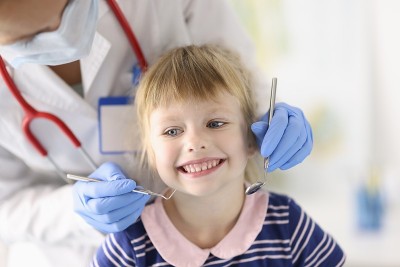 Little girl smiles at dentist appointment closeup