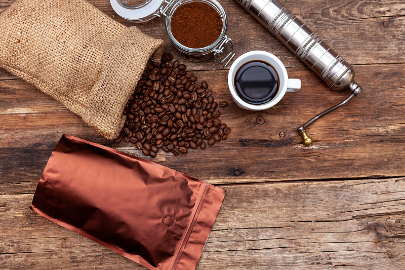 Bag of coffee on a wooden table. Coffee beans grou