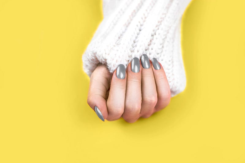 Beautiful art manicure of modern yellow and gray c