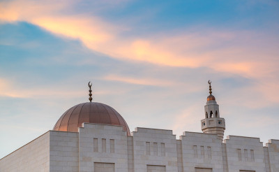Muslim mosque minaret with dark cloud during the r