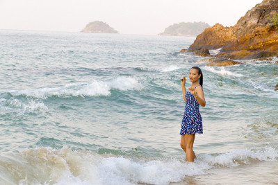 Woman and wave happy morning in Lonely Beach