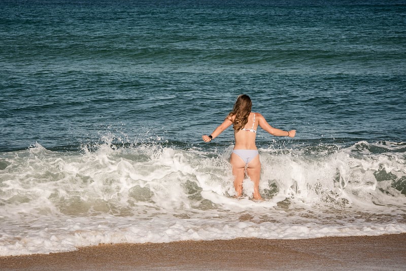 一个年轻漂亮的女人在海里洗澡