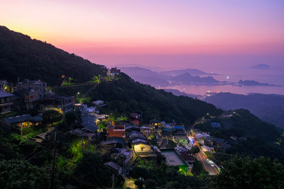 一幅海洋、山脉和美丽天空的景观全景图。T