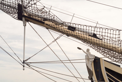 Figure on the prow of an old ship.Rigging.