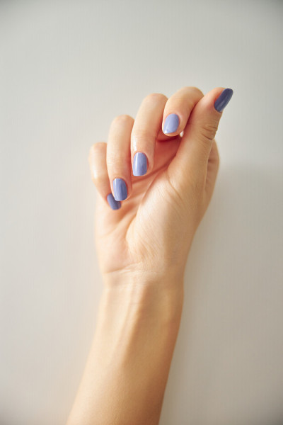 Woman hand with fashionable bright colour manicure