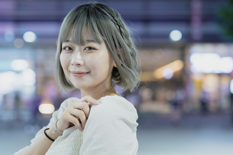 Young woman posing in Tokyo city at night