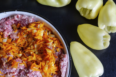 Bowl of raw minced meat and sauteed vegetables for