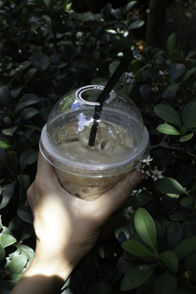 Hand on iced coffee drink