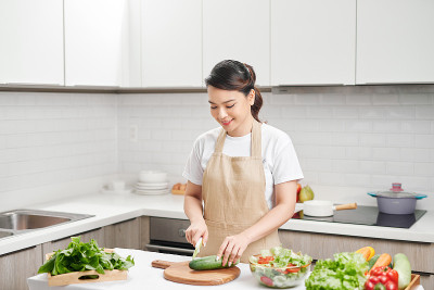 Woman在厨房切蔬菜