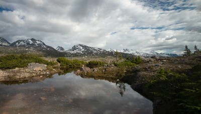 聚焦白口山顶外克朗代克高速公路沿线的雪山形成的湖泊，蓝天白云