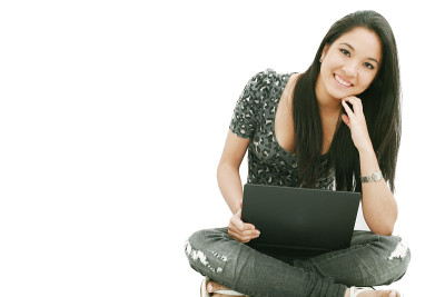 年轻女性坐在地板上用笔记本电脑