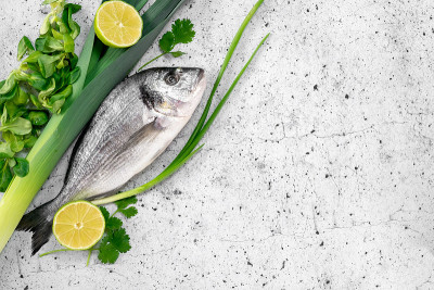 Raw fresh dorada fish with herbs, onion and lime i