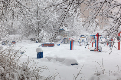 正在下雪，堆了很多雪。新雪覆盖，白雪覆盖的树木和操场。