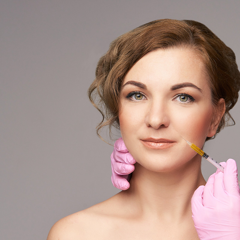 Face needle injection. Young woman cosmetology pro