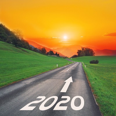 在田园诗般的开阔道路上，迎着夕阳，在大山中向着目标前行，直到2020年新年。成功的概念，流逝的时间和