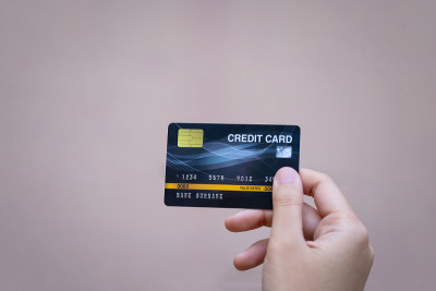 Close up of female hand holding a credit card in h