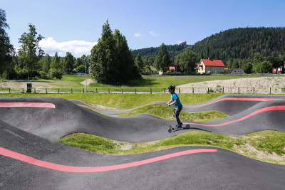 男孩骑kickbike在Järvsö泵轨道