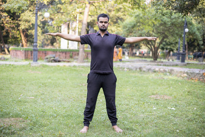 Young Indian man doing yoga asanas and exercise in