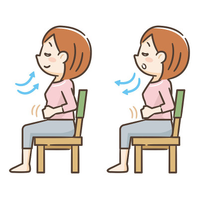 Young woman sitting in a chair and taking a deep b